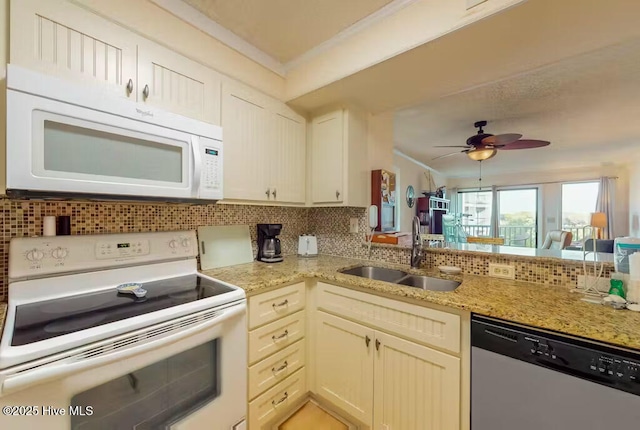 kitchen with sink, crown molding, ceiling fan, white appliances, and decorative backsplash