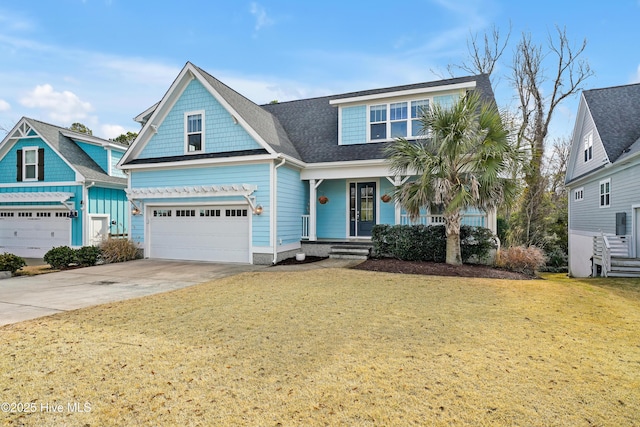 view of front of home featuring a front yard, an attached garage, driveway, and a shingled roof