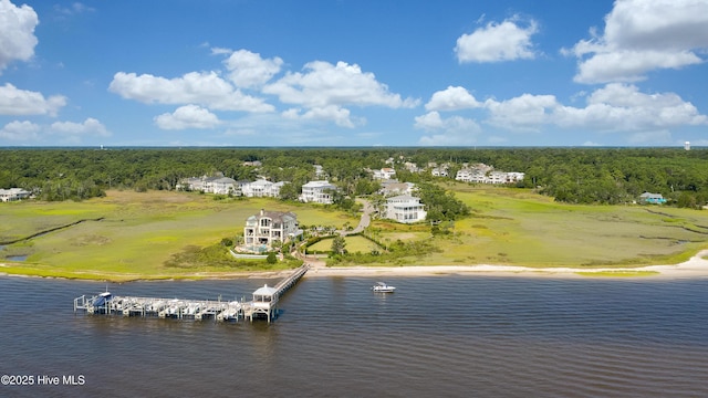 aerial view featuring a forest view and a water view