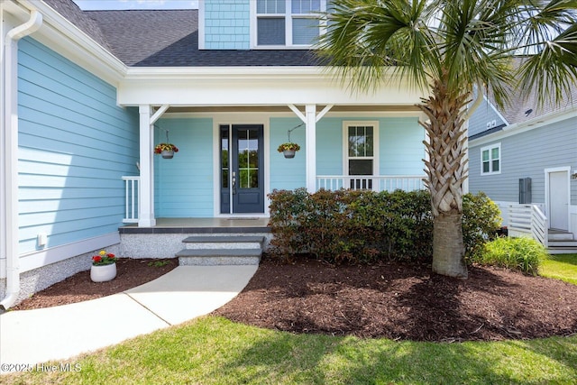 property entrance featuring a porch and roof with shingles