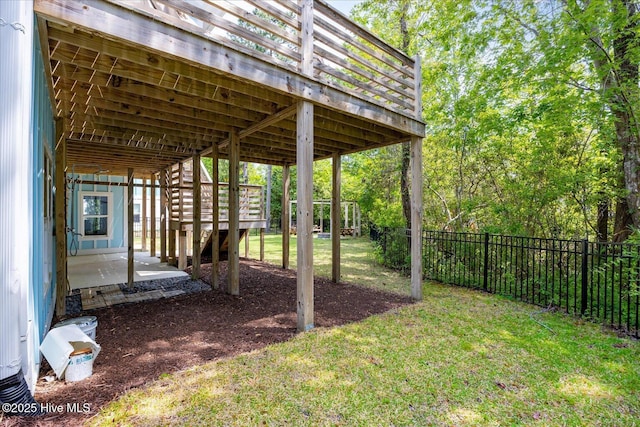 view of yard with stairs, fence, and a deck
