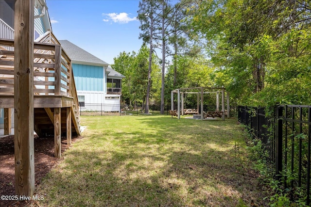 view of yard with a fenced backyard, a wooden deck, and stairway