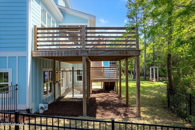 exterior space featuring fence, a wooden deck, and stairs