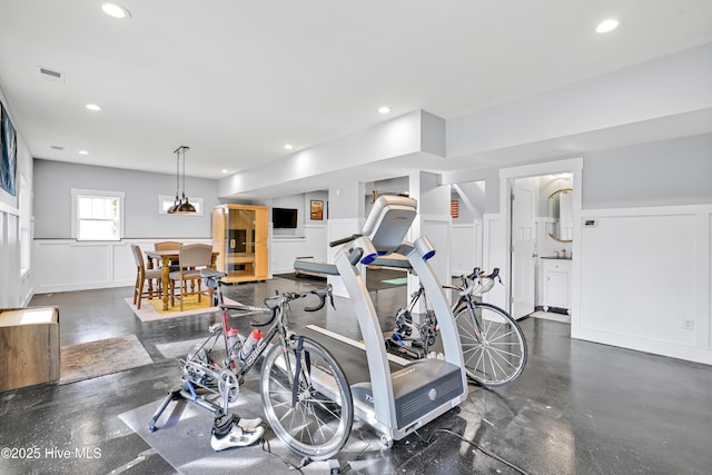 workout room featuring visible vents, recessed lighting, and a decorative wall