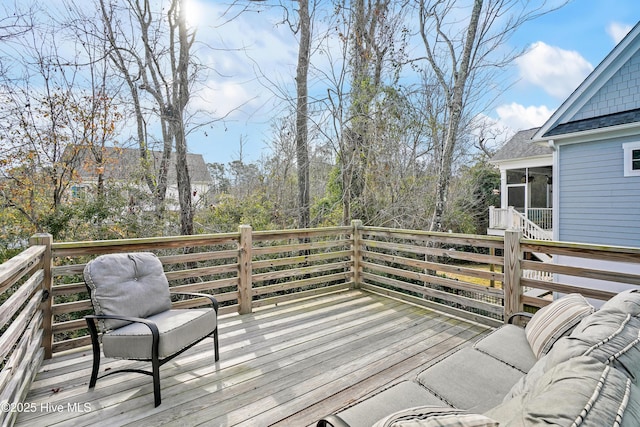 wooden deck with a sunroom