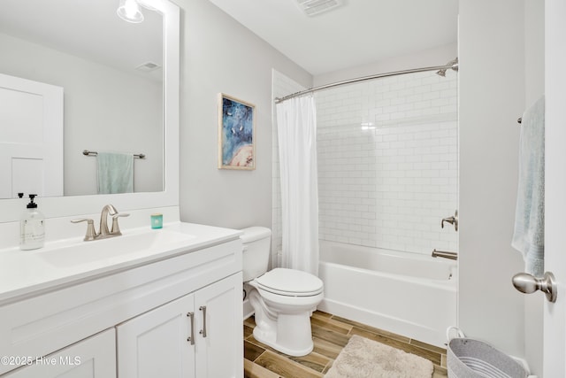 full bath featuring wood finished floors, vanity, shower / bath combination with curtain, toilet, and visible vents