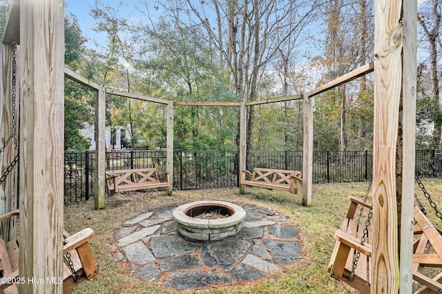 view of yard featuring a fire pit and a fenced backyard