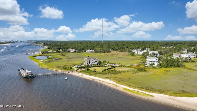birds eye view of property featuring a water view and a wooded view