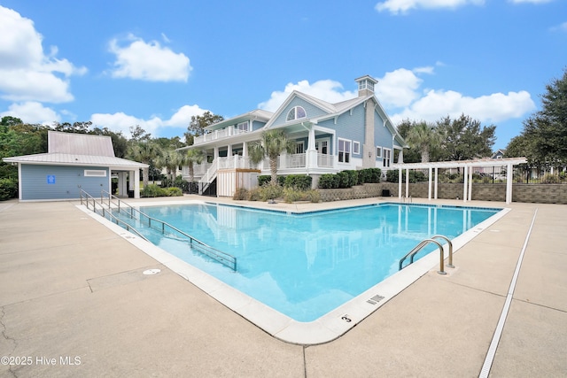 community pool with stairway and a patio area