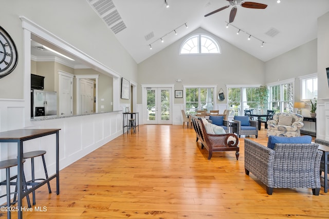 living room featuring rail lighting, ceiling fan, visible vents, and light wood-style flooring