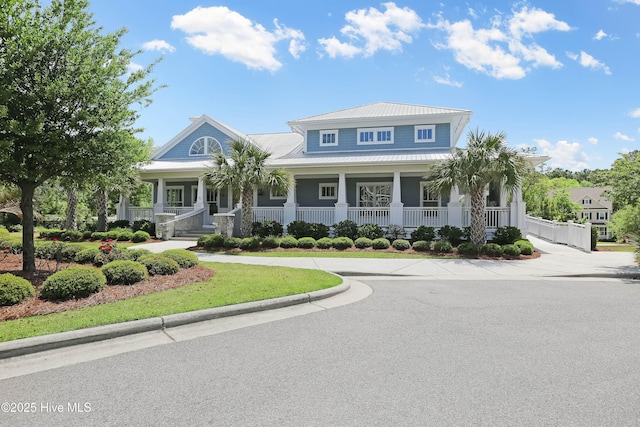 view of front of property featuring a porch, metal roof, and a standing seam roof