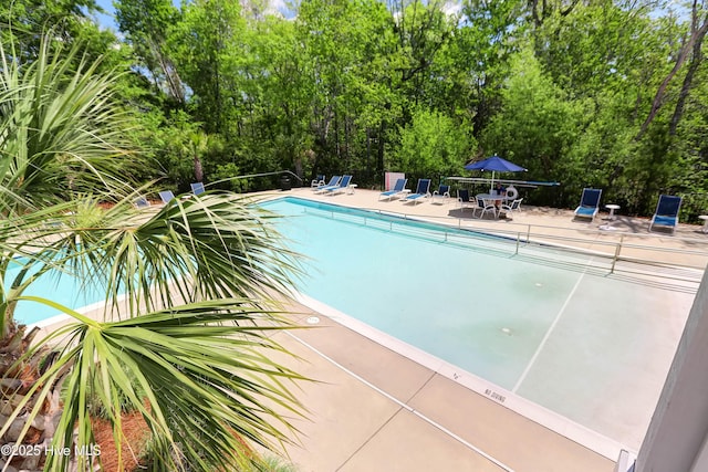 pool featuring a patio area and fence