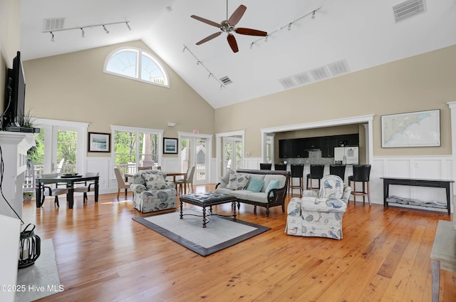 living room featuring visible vents, light wood-style floors, and a fireplace