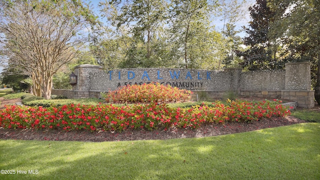 community / neighborhood sign with a yard