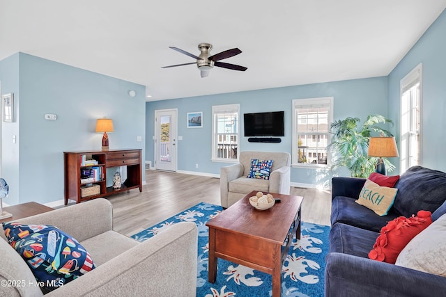 living room featuring hardwood / wood-style flooring and ceiling fan