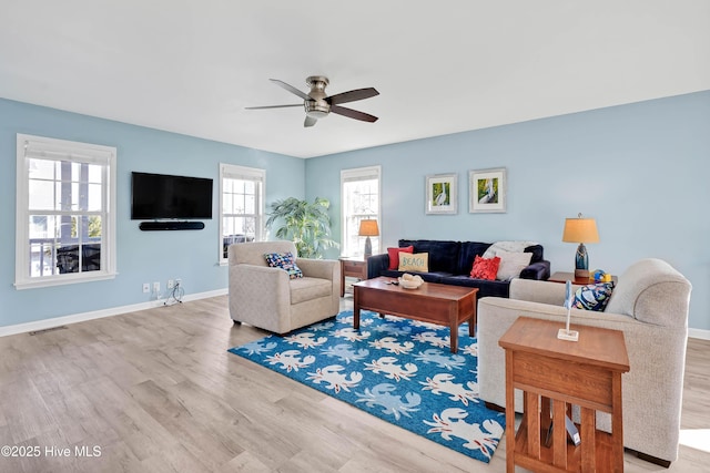 living room featuring light hardwood / wood-style floors and ceiling fan