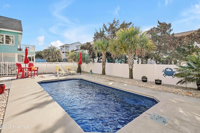 view of swimming pool featuring a patio area