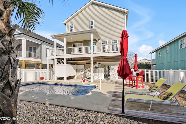 rear view of house with a swimming pool side deck