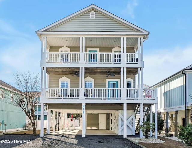 beach home with ceiling fan and a carport