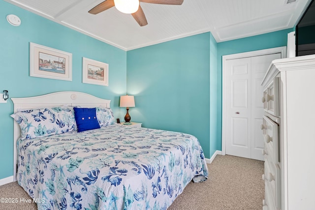 carpeted bedroom featuring ceiling fan and a closet