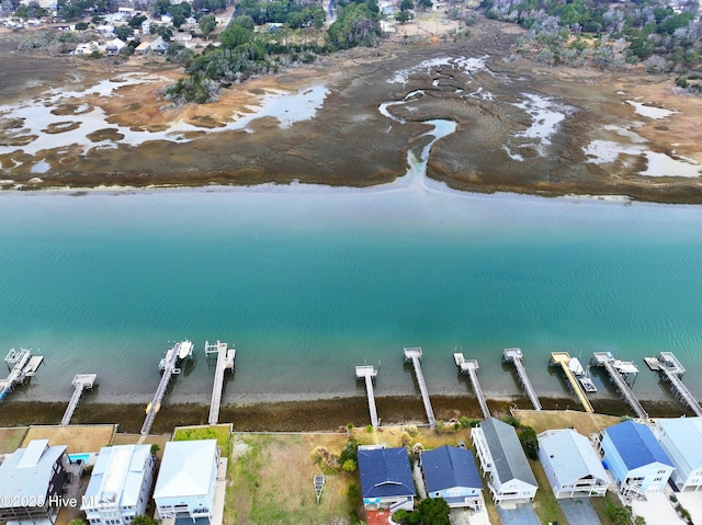 aerial view with a water view and a beach view