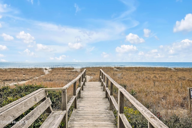 view of home's community featuring a water view and a view of the beach