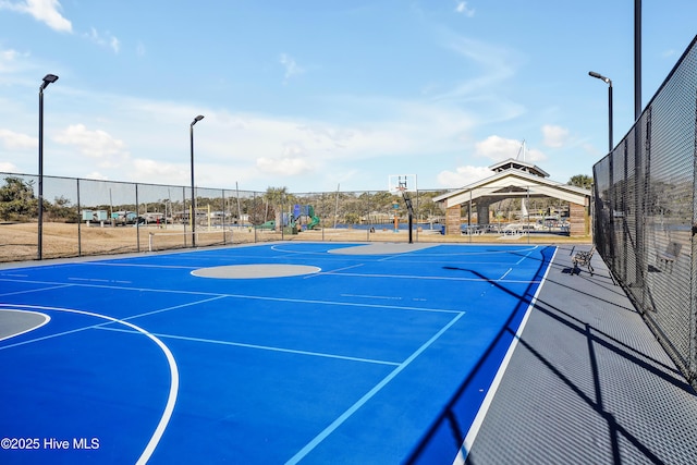 view of sport court featuring a gazebo and a playground