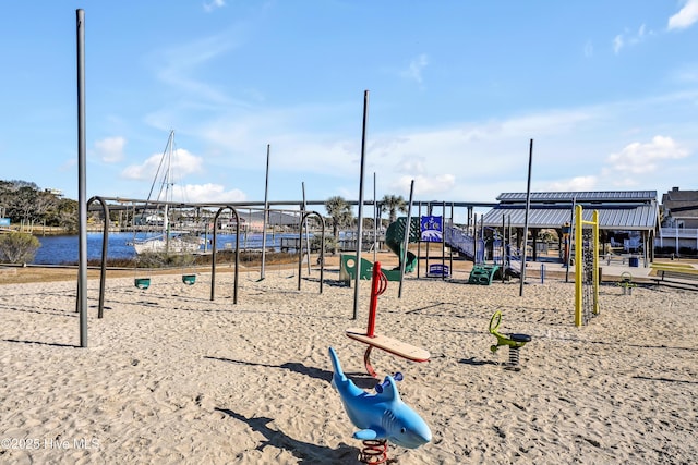 surrounding community with a water view and a playground