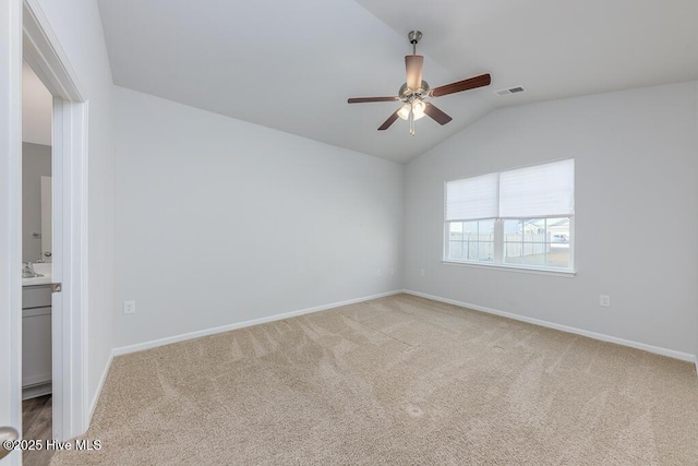 unfurnished room featuring lofted ceiling, ceiling fan, and carpet