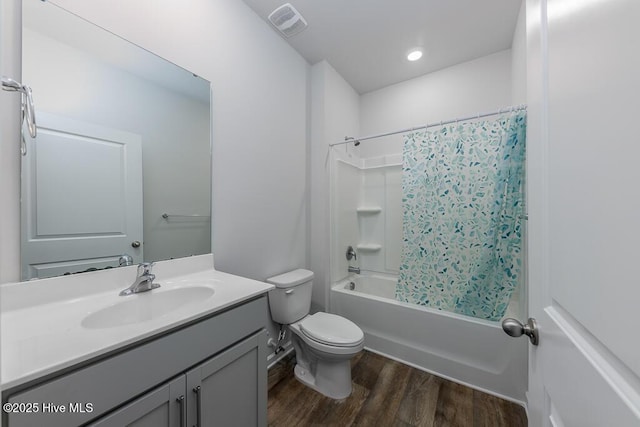 full bathroom with hardwood / wood-style flooring, vanity, toilet, and shower / bath combo with shower curtain