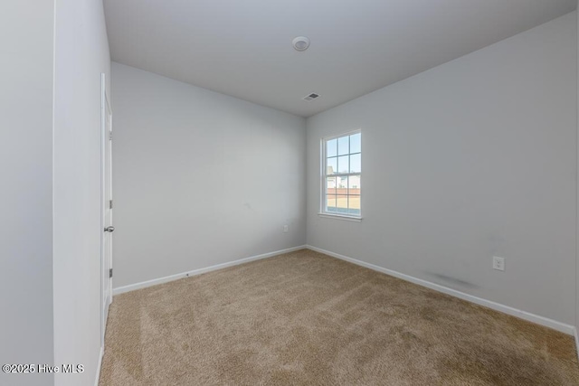 unfurnished room with light carpet