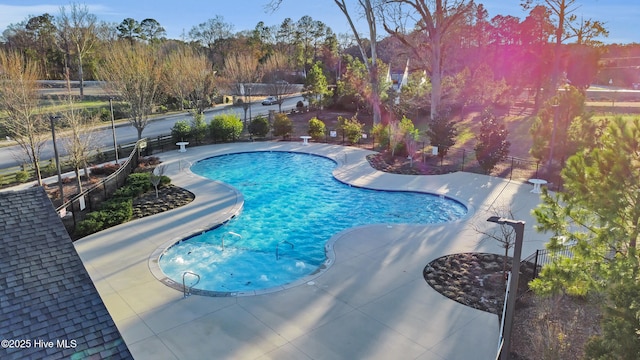 community pool featuring a patio area and fence