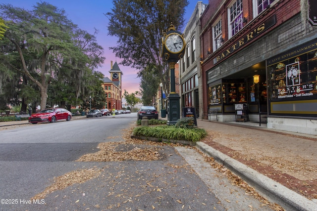 view of street featuring sidewalks, street lights, and curbs