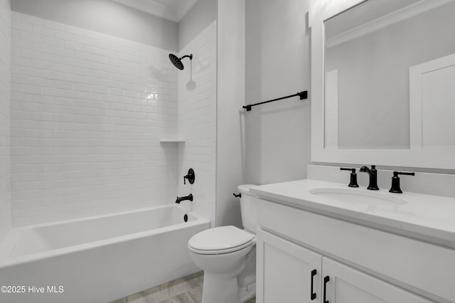 full bathroom featuring tiled shower / bath combo, vanity, and toilet