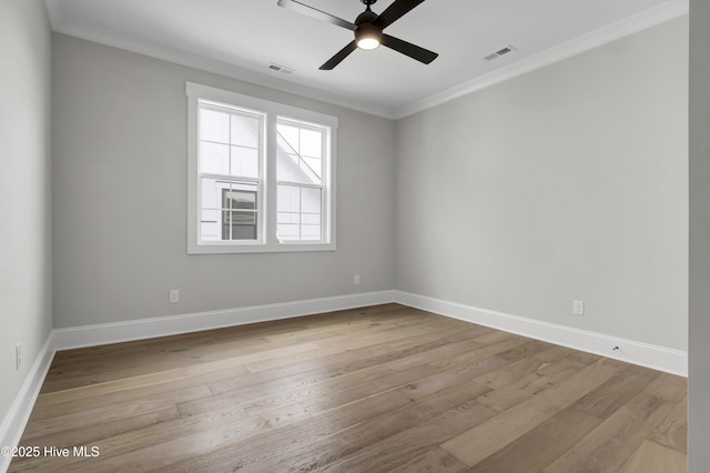 spare room with crown molding, ceiling fan, and light wood-type flooring