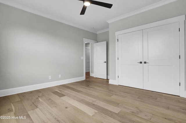 unfurnished bedroom with crown molding, ceiling fan, light hardwood / wood-style floors, and a closet