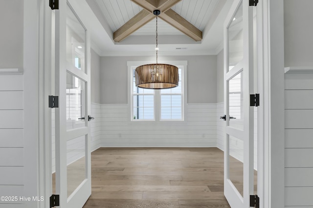 interior space featuring coffered ceiling, beam ceiling, and light wood-type flooring