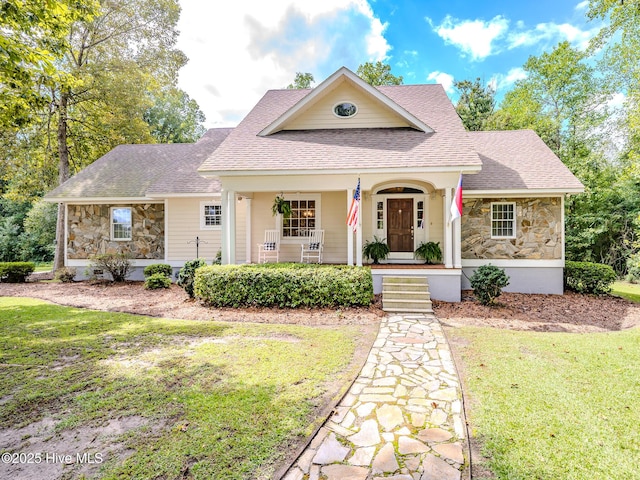 view of front of property with a front yard and a porch