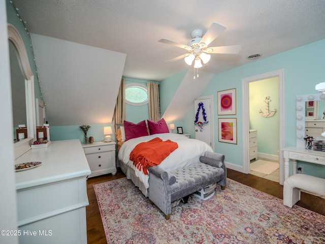 bedroom featuring lofted ceiling, ceiling fan, dark wood-type flooring, and a textured ceiling