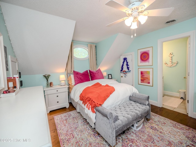 bedroom featuring vaulted ceiling, ceiling fan, light hardwood / wood-style floors, and a textured ceiling