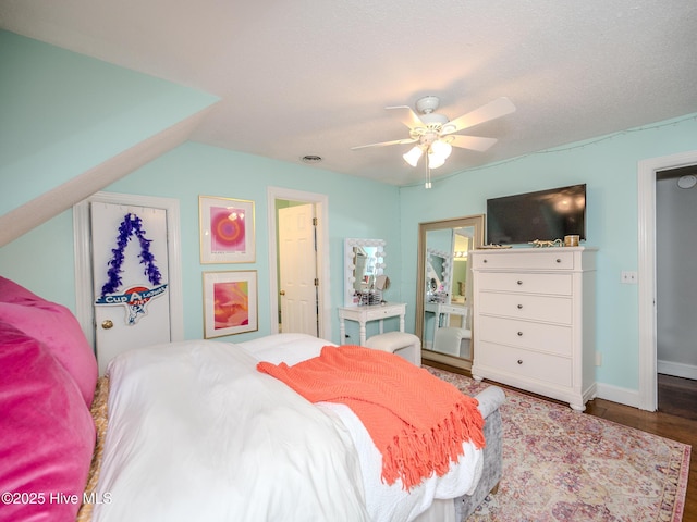 bedroom with wood-type flooring and ceiling fan