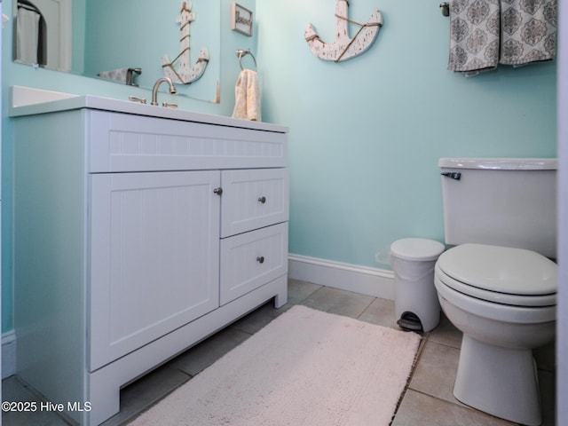 bathroom with tile patterned floors, vanity, and toilet