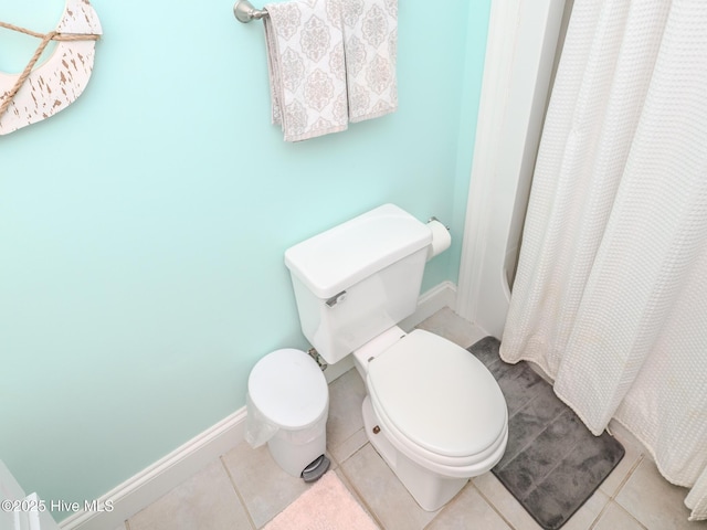 bathroom with tile patterned floors, toilet, and a shower with shower curtain