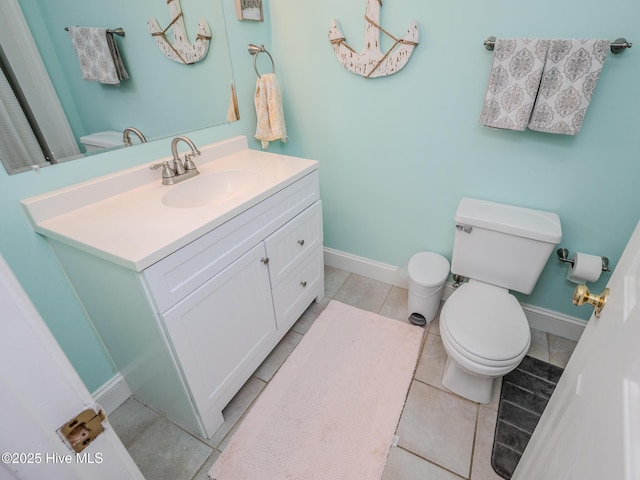 bathroom featuring vanity, tile patterned flooring, and toilet