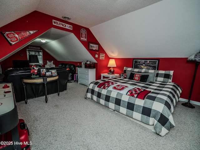 bedroom with vaulted ceiling, carpet flooring, and a textured ceiling