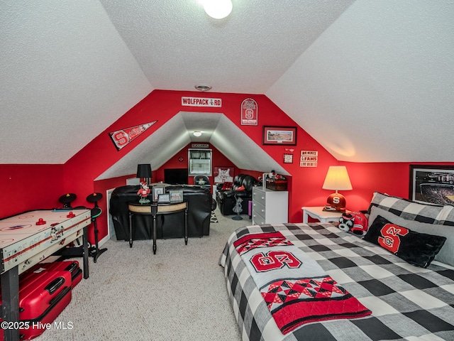 bedroom featuring vaulted ceiling and a textured ceiling