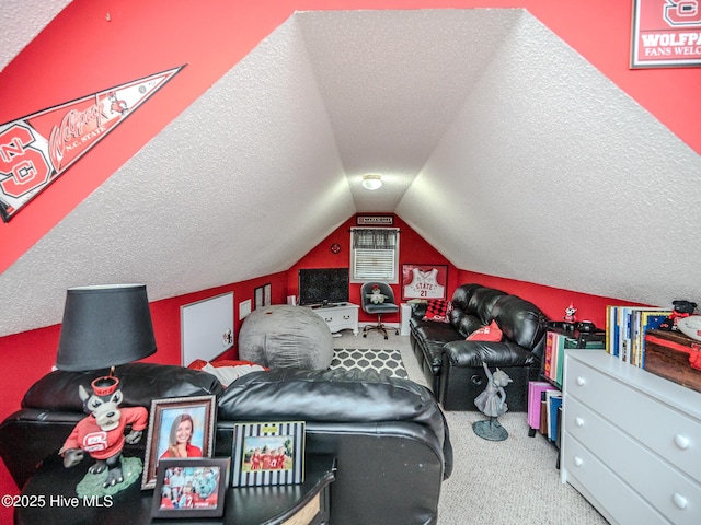 interior space featuring carpet floors, a textured ceiling, and vaulted ceiling