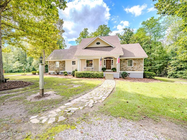 view of front of property with covered porch and a front lawn