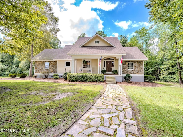 view of front facade with covered porch and a front lawn