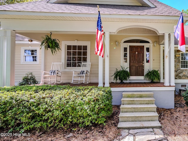 view of exterior entry featuring a porch